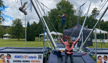 Children jumping safely on a Eurojumper bungee trampoline at an outdoor family event